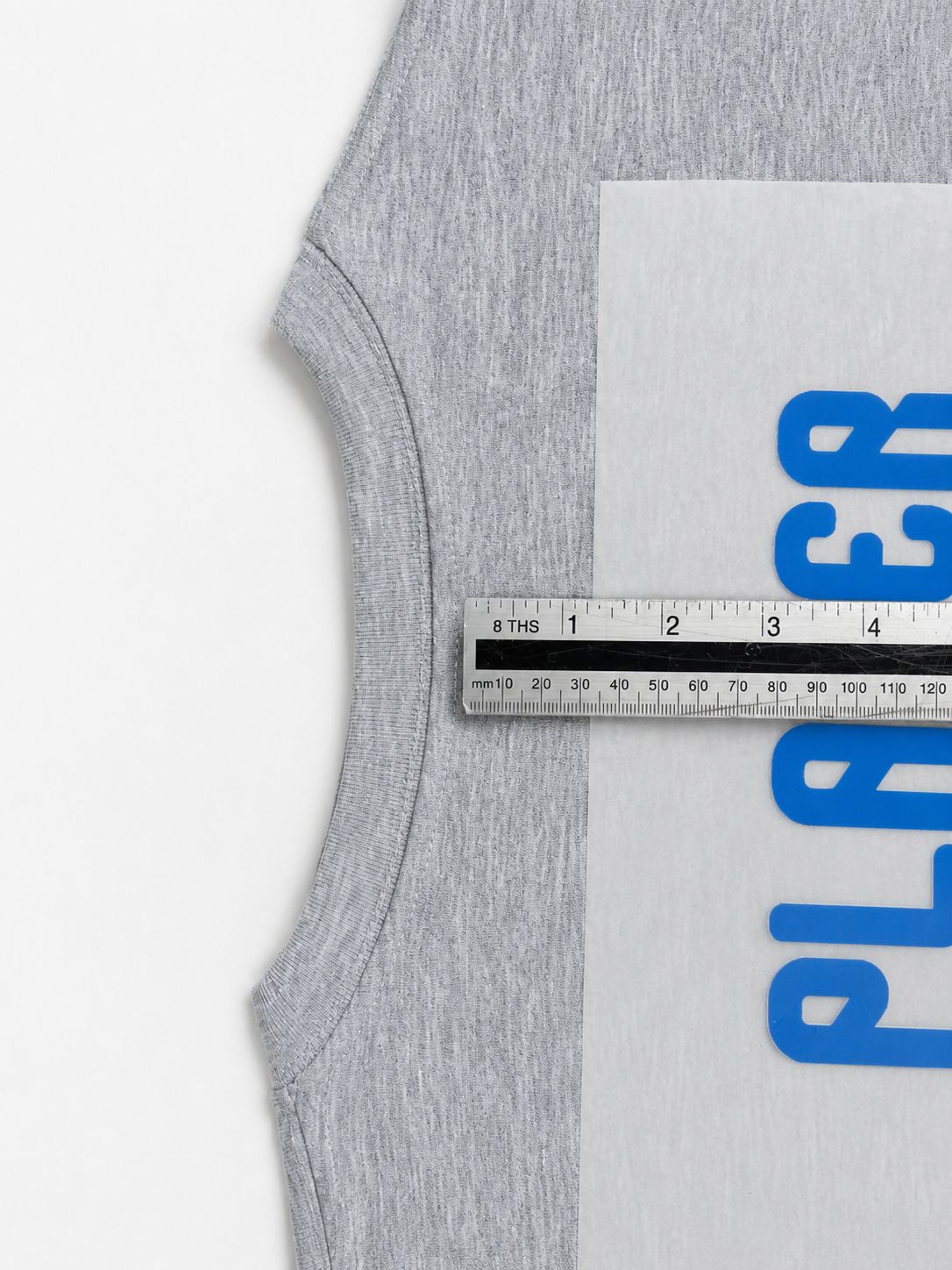Using a ruler to measure and position the transfer on the jersey